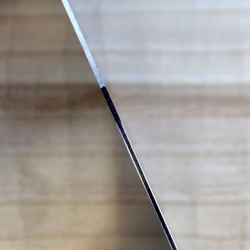 Closeup of Accu-Burr hook on surface ground scraper edge